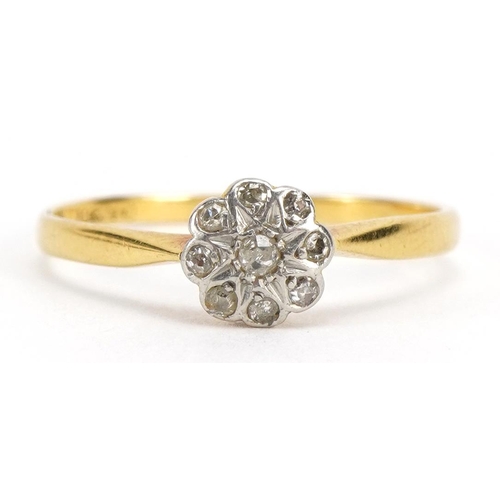 1124 - 18ct gold diamond flower head ring set with nine diamonds, size M, 1.4g