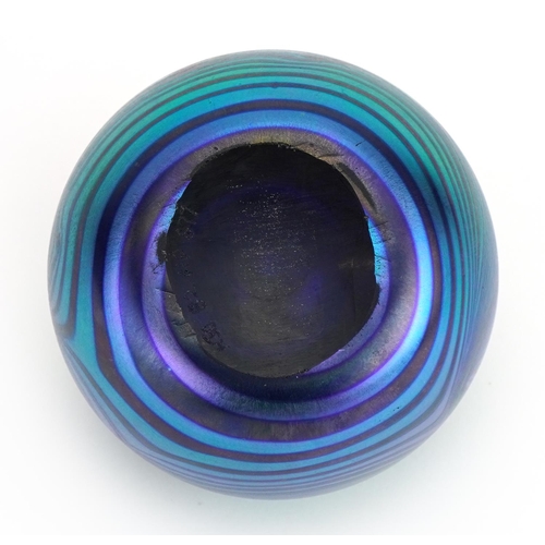 36 - Iridescent art glass paperweight with combed decoration, etched marks to the base, 6.5cm high
