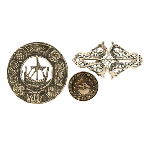 1126 - Three Celtic design silver brooches including one set with a citrine and a Viking longboat example, ... 