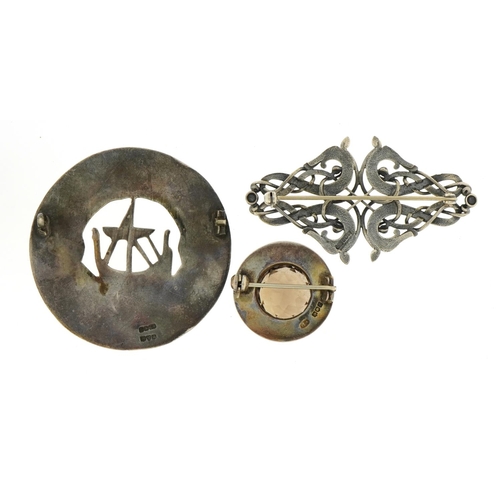 1126 - Three Celtic design silver brooches including one set with a citrine and a Viking longboat example, ... 