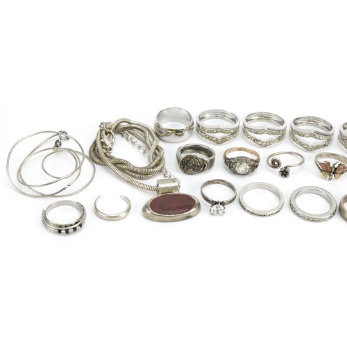 1551 - Silver and white metal jewellery comprising eighteen rings, two necklaces and a pendant, total 98.6g