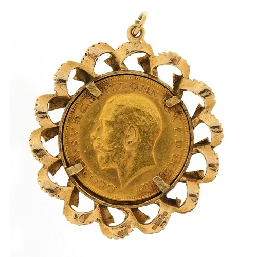 1003 - George V 1911 gold sovereign housed in a 9ct gold pendant mount, 4cm high, 12.7g