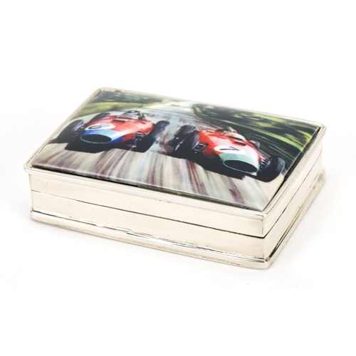 189 - Rectangular silver and enamel pill box, the hinged lid decorated with Formula 1 cars, 5cm wide, 39.0... 