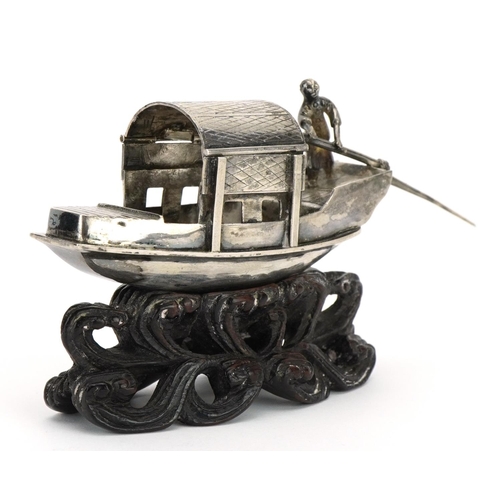 165 - Luen Wo, Chinese silver model of a boat raised on a carved hardwood stand, 9.5cm in length, 43.3g