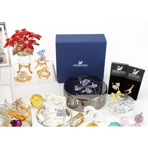 8 - Collection of mostly Swarovski Crystal including miniature flowers raised on a stand, snowflake broo... 