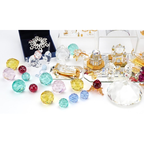 8 - Collection of mostly Swarovski Crystal including miniature flowers raised on a stand, snowflake broo... 