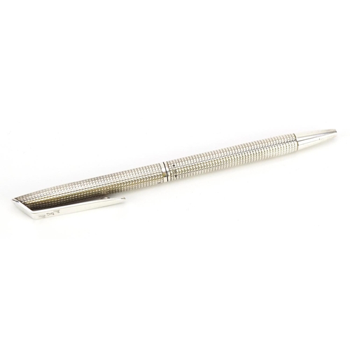 81 - Silver ballpoint pen with engine turned body, 13.5cm in length