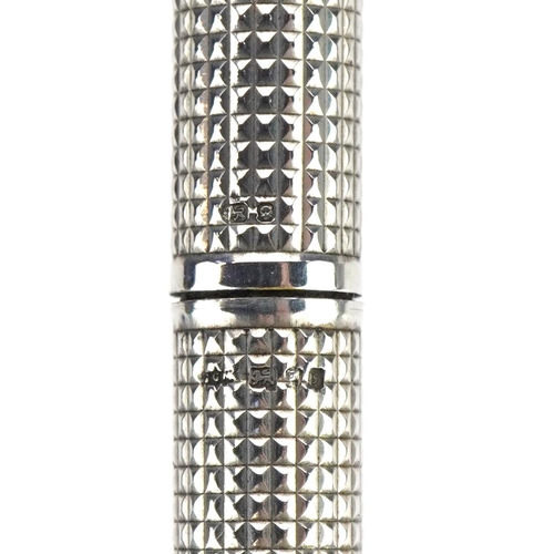 81 - Silver ballpoint pen with engine turned body, 13.5cm in length