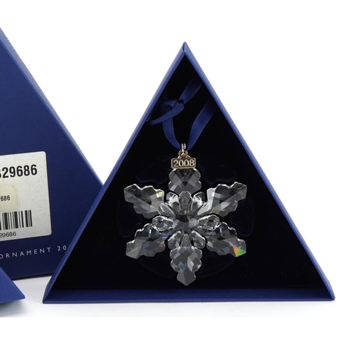 12 - Two Swarovski Crystal Christmas ornaments with boxes comprising dates 2008 and 2009