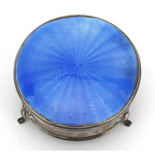 176 - George V circular silver and blue guilloche enamel jewel box with hinged lid, raised on three feet, ... 
