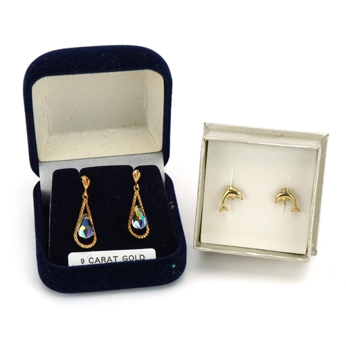 1499 - Two pairs of unmarked gold earrings comprising a pair of crystal drops and pair of dolphins, the lar... 