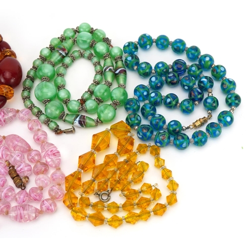 1611 - Five vintage necklaces including Venetian painted glass beads and cherry amber coloured beads