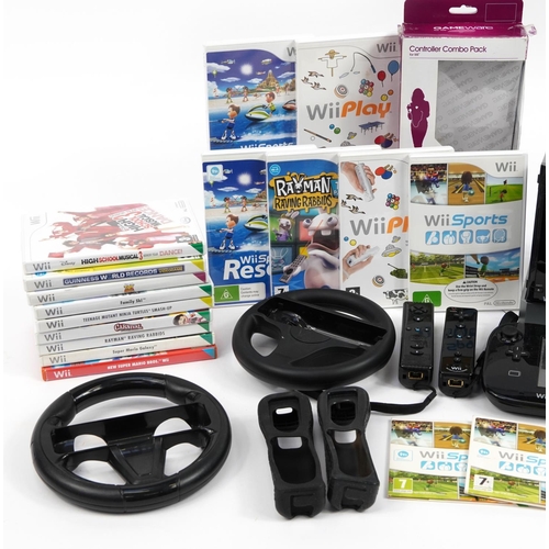 343 - Black Nintendo Wii and Nintendo Wii U games consoles with controllers, accessories and a collection ... 