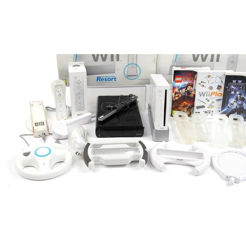 334 - Two Nintendo Wii games consoles with controllers, accessories and games