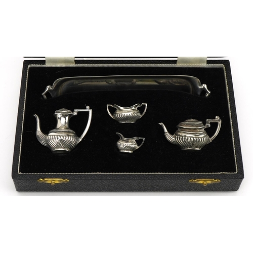 143 - A Marston & Co, Elizabeth II silver five piece doll's house tea and coffee service housed in a velve... 