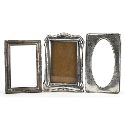 157 - Three silver mounted photo frames, various hallmarks, the largest 18cm x 12.5cm