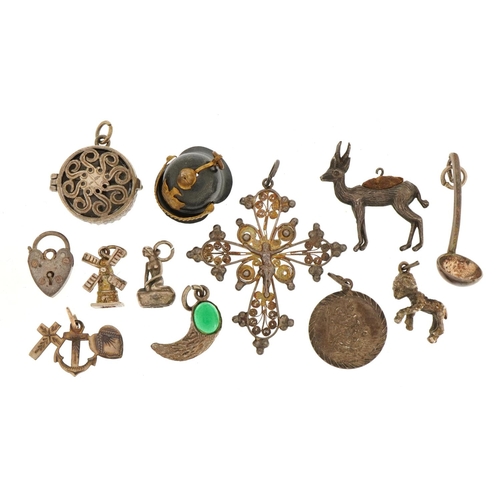 1556 - Collection of silver and white metal charms and pendants including a Pickelhaube helmet, crucifix an... 