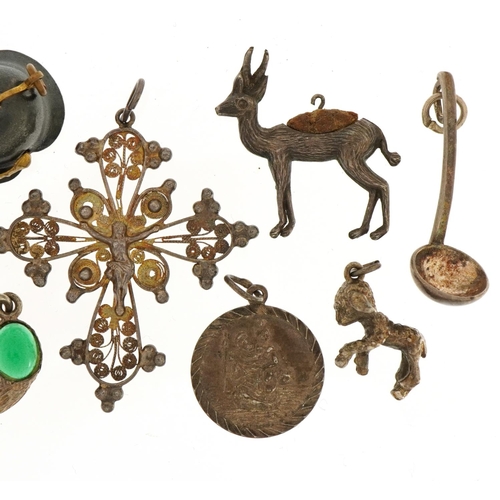 1556 - Collection of silver and white metal charms and pendants including a Pickelhaube helmet, crucifix an... 