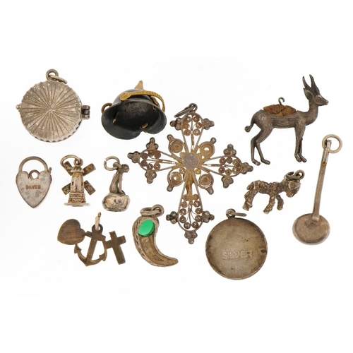 1556 - Collection of silver and white metal charms and pendants including a Pickelhaube helmet, crucifix an... 