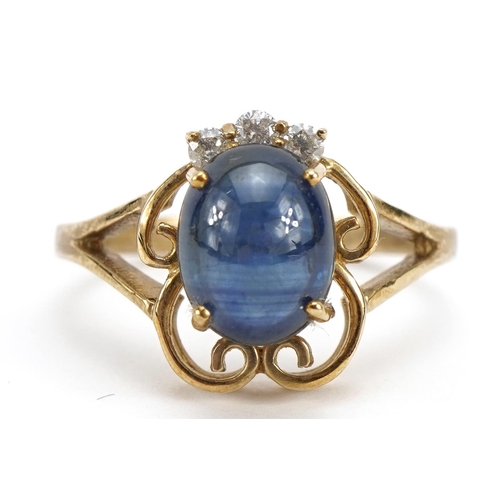 1122 - 9ct gold cabochon sapphire ring set with three diamonds, the sapphire stone approximately 9.1mm x 7.... 