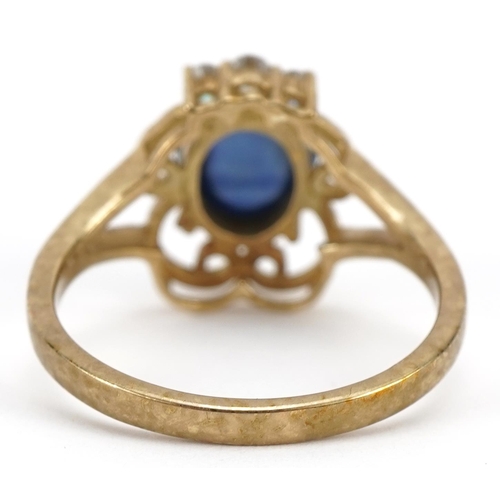 1122 - 9ct gold cabochon sapphire ring set with three diamonds, the sapphire stone approximately 9.1mm x 7.... 