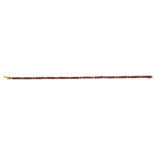 1058 - 9ct gold cabochon ruby line bracelet, 19.5cm in length, 11.3g