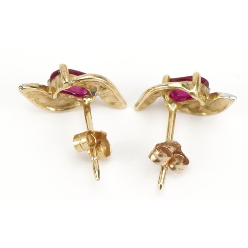 1113 - Pair of unmarked gold ruby and diamond crossover stud earrings, 1.2cm high, 0.9g