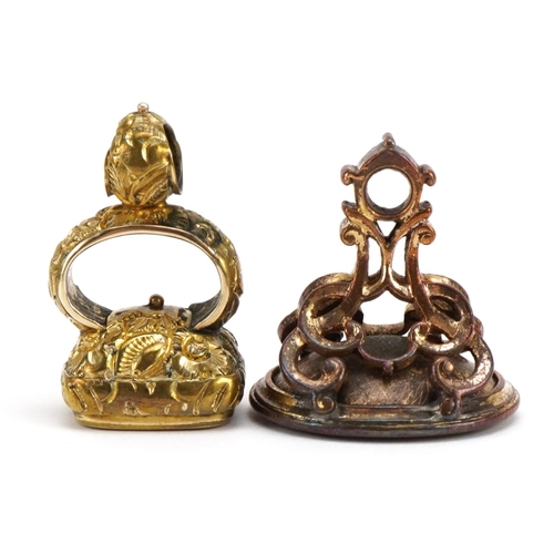 1594 - Two antique yellow metal carnelian seal fobs including one carved with a heraldic crest, the largest... 