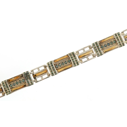 1578 - Silver and gilt panel bracelet set with blue stones, tests as sapphire, 20cm in length, 28.9g