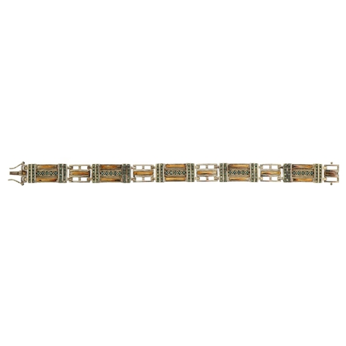 1578 - Silver and gilt panel bracelet set with blue stones, tests as sapphire, 20cm in length, 28.9g