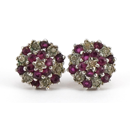 1076 - Pair of 9ct gold diamond and ruby three tier cluster stud earrings, 9mm in diameter, 1.6g