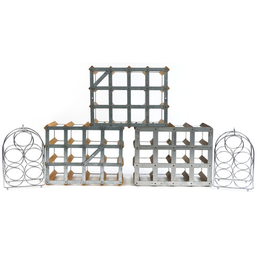 136A - Three vintage twelve bottle wine racks and a pair of stainless steel five bottle wine racks, the lar... 