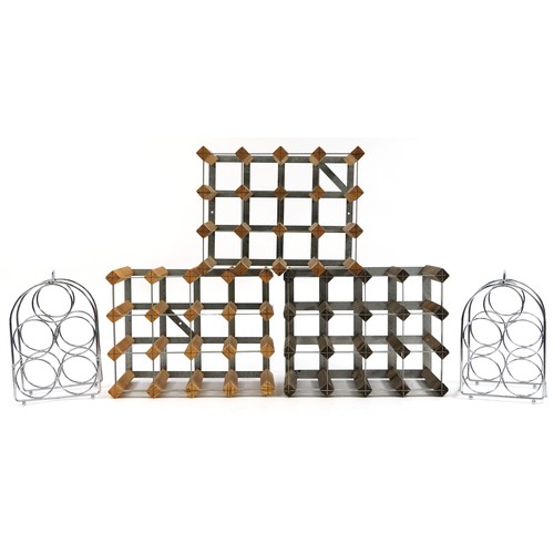 136A - Three vintage twelve bottle wine racks and a pair of stainless steel five bottle wine racks, the lar... 