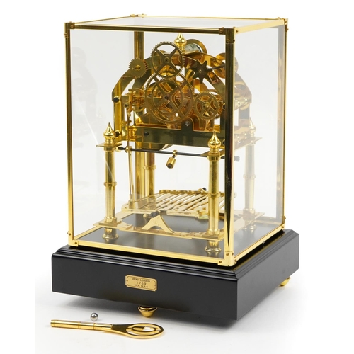 311 - Congreve style rolling ball clock housed under a glazed brass display case with ebonised base, 42cm ... 