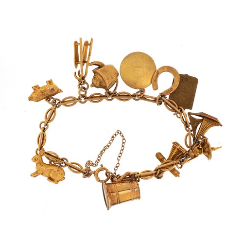 1007A - 9ct gold charm bracelet with a selection of mostly gold charms, including ballerina, horseshoe and i... 