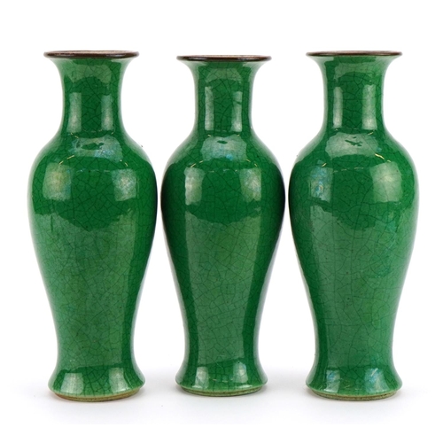 516 - Garniture of three Chinese porcelain baluster vases  having green crackle glazes, each 23cm high