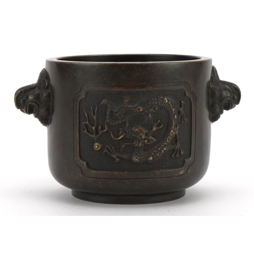 196 - Chinese patinated bronze censer with twin handles cast with panels of dragons chasing a flaming pear... 