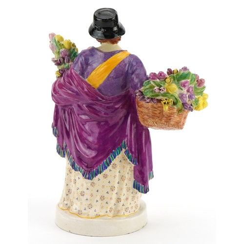 93 - Charles Vyse, Chelsea Pottery figurine of a mother with child holding flowers, signed and dated 1921... 