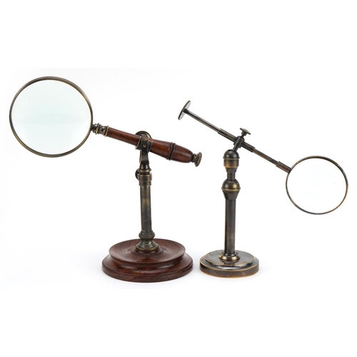 423 - Rosewood desk magnifying glass holder with magnifying glass and a bronzed example, the largest magni... 