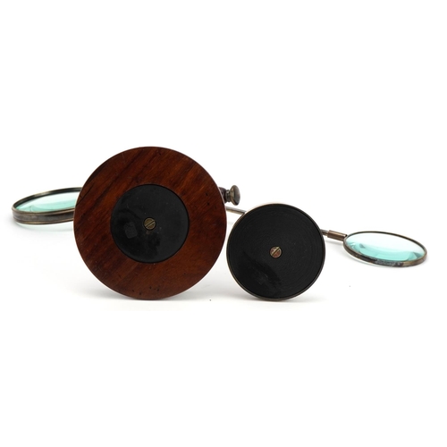 423 - Rosewood desk magnifying glass holder with magnifying glass and a bronzed example, the largest magni... 