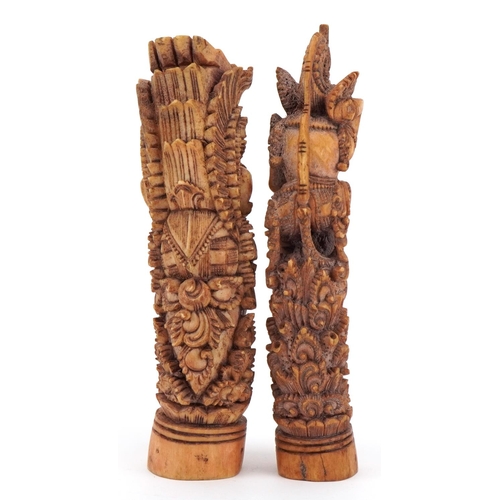 276 - Two Burmese carved bone mythical figures, one with a serpent, the largest 16cm high