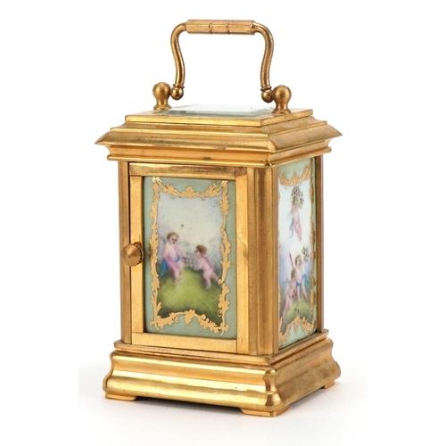 86 - Miniature brass cased carriage clock with swing handle and Sevres style panels, hand painted with ch... 