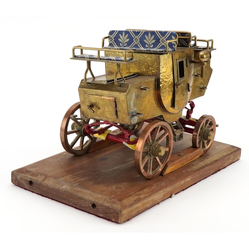 371 - Scratch built brass, copper and iron stagecoach raised on a wooden plinth base, 32cm in length