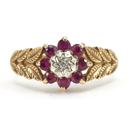 9ct gold ruby and diamond flower head ring, with leaf design shoulders