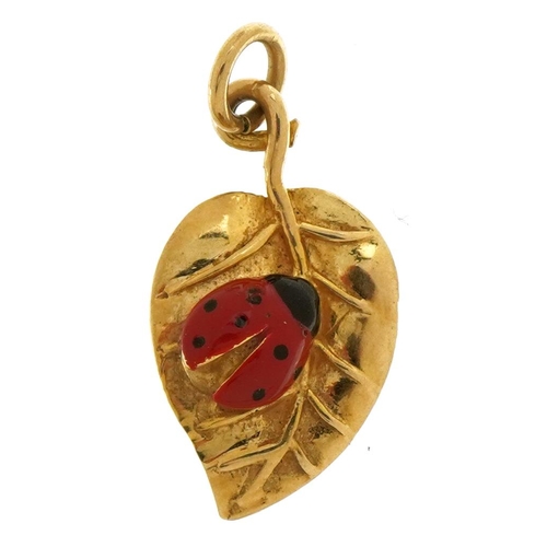 2594 - 9ct gold and enamel ladybird on leaf charm, 1.9cm high, 1.3g