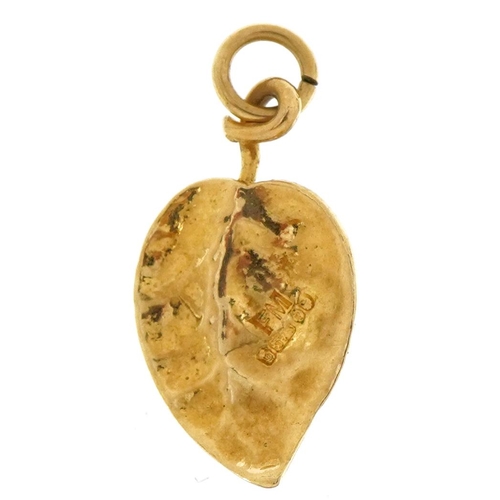 2594 - 9ct gold and enamel ladybird on leaf charm, 1.9cm high, 1.3g