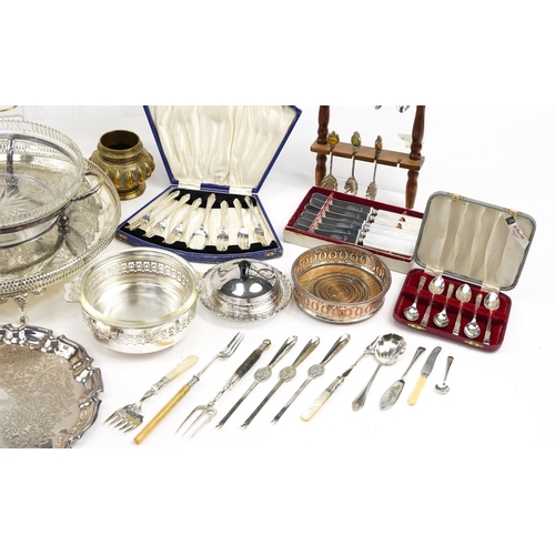 1233 - Silver plate including circular four footed salver, souvenir teaspoons on display stands, cruets, cu... 