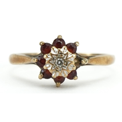 2120 - 9ct gold garnet and diamond flower head ring, Birmingham 1975, size L, 1.3g