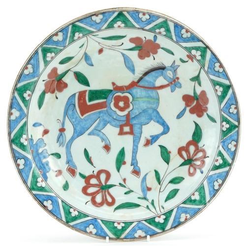 136 - Turkish Ottoman Iznik shallow dish hand painted with a horse and flowers, 32cm in diameter