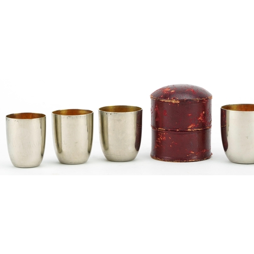 370 - WMF, graduated set of six German silver plated shot glasses with gilt interiors housed in a red leat... 